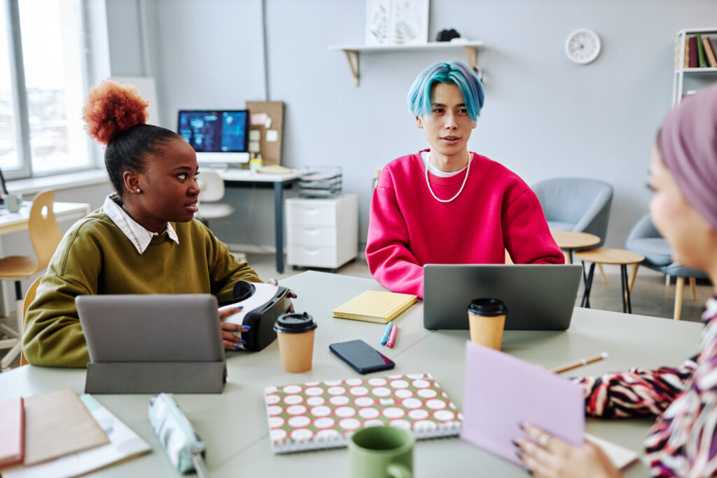 Diverse group of creative young people meeting in office.