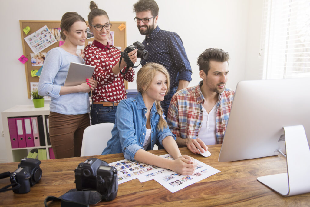 Busy marketing team looking over their work in an office.