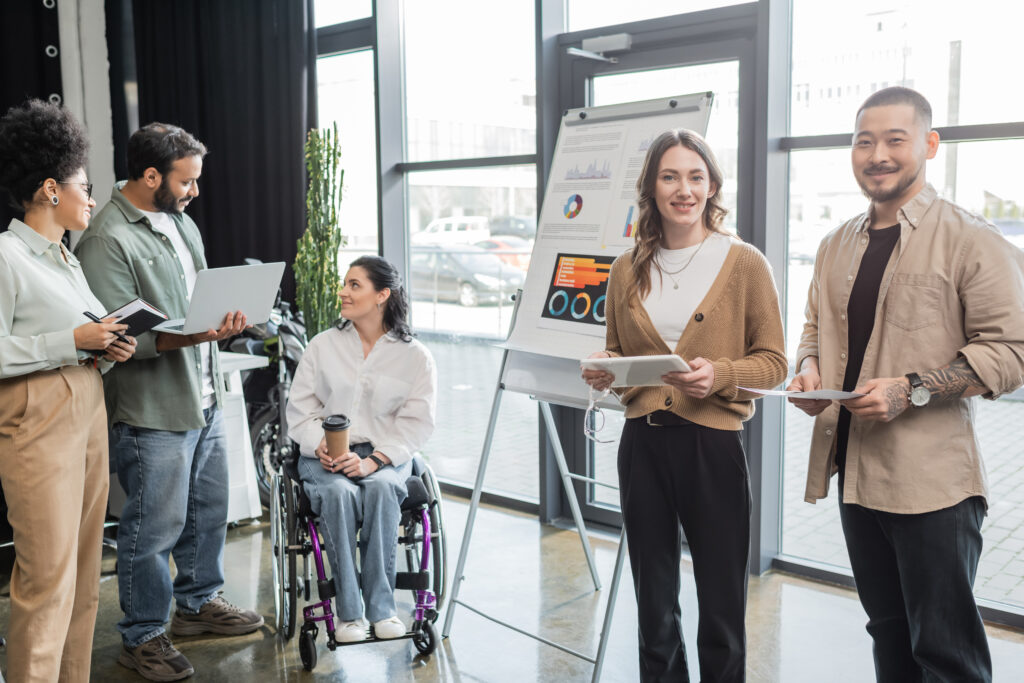 A diverse team planning project with wheelchair-user coworker