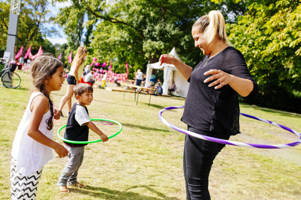 Mother, daughter and son playing with hula hoops