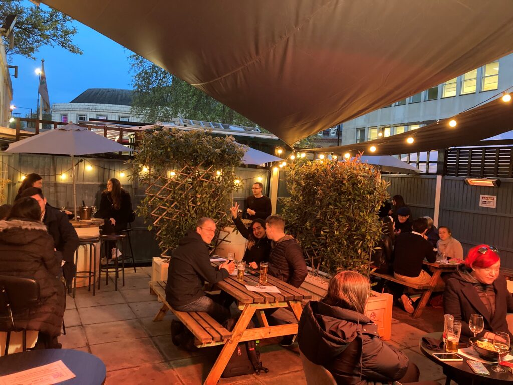 The Thirsty Scholar Beer Garden filled with people in the evening