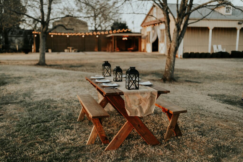 An autumn outdoor table gathering with shelter in the background