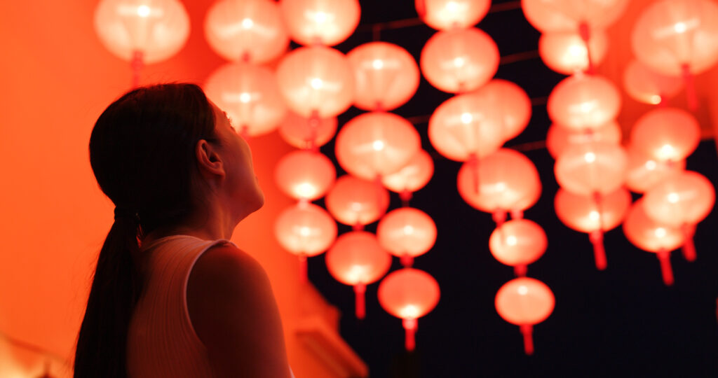 Woman look at the red lantern for mid autumn festival 