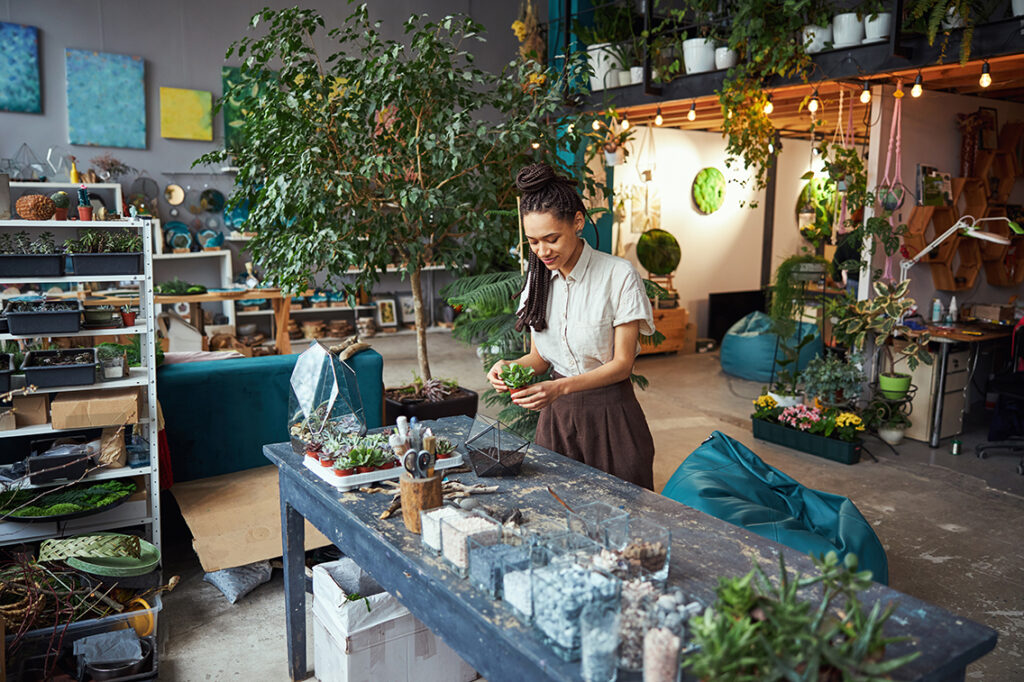 professional florist with a potted succulent in her hands in a plant shop